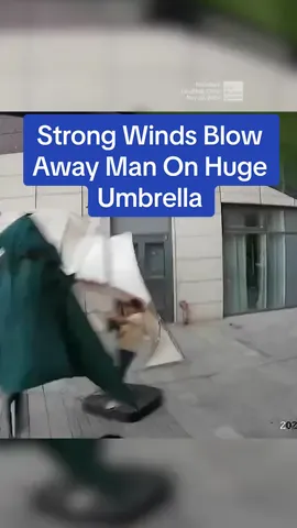 A man was trying to stop a huge sunshade umbrella from being blown away when strong winds took both of them flying. #TheWeatherChannel #fyp #weathertok #weather #wind #umbrella #funny #fail #weatherchannel 