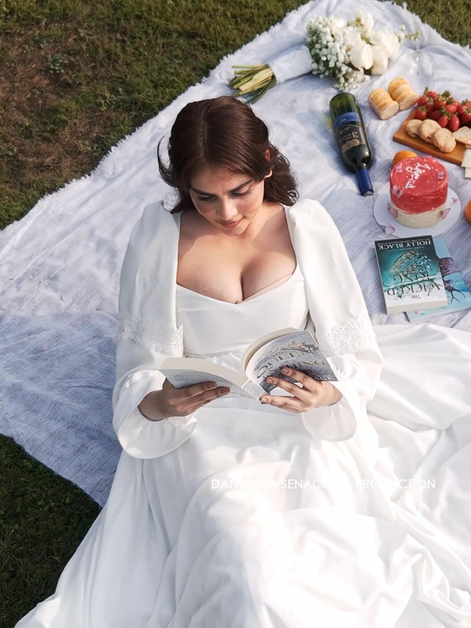 A quiet birthday moment under the open sky…   soft light, gentle breeze, and a story unfolding between pages and petals. ✨   Liyena | Birthday Shoot For Inquiries : 076 930 0008   #danushkasenadeera #manbehindthelens #birthdayphotoshoot #dreamyphotoshoot #fairytalephotoshoot