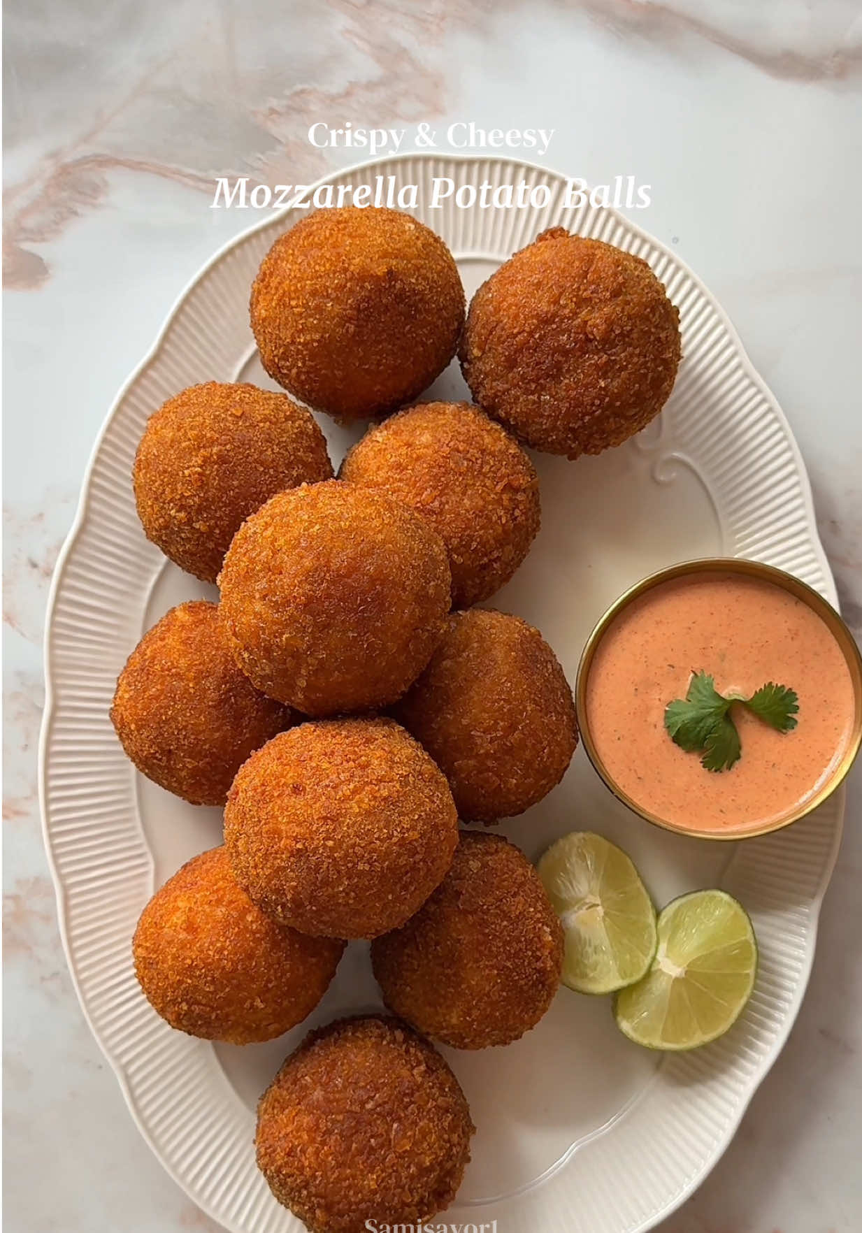 Super Crispy Cheesy Mozzarella Potato Balls 🧀✨ These crispy mozzarella potato balls are golden and crunchy on the outside, soft and fluffy on the inside, with the ultimate gooey cheese pull. The perfect party snack, appetiser, or comfort food recipe! 📝 Ingredients Potato Balls * 8 medium potatoes, peeled * 1 tsp salt (plus extra for boiling) * 2 tsp chicken bouillon powder * 2 tsp onion powder * 2 tsp garlic powder * 1 tsp smoked paprika * 2 eggs * 1 cup shredded mozzarella * ¾ cup grated Parmesan * 1 cup mozzarella, cut into small cubes Crispy Coating * 1 cup plain flour * 2 eggs, beaten * 2 cups crushed cornflakes (or breadcrumbs) Spicy Mayo * ½ cup mayonnaise * 1 tbsp sriracha * ½ tsp smoked paprika * ½ tsp garlic powder * ½ tsp onion powder * ½ tsp dried parsley 👩‍🍳 Instructions 1. Boil the potatoes in generously salted water until fork tender. Drain well and mash until completely smooth. 2. Add the salt, chicken bouillon, onion powder, garlic powder, smoked paprika, eggs, shredded mozzarella, and Parmesan. Mix until fully combined. 3. Refrigerate the mixture for 30 minutes to firm up. 4. Scoop out portions of the potato mixture and flatten slightly in your hand. Place a cube of mozzarella in the centre, then seal and roll into a smooth ball. 5. Freeze for 1 hour, or until firm. 6. Coat each potato ball in flour, then dip into the beaten eggs, and finally coat well with the crushed cornflakes (or breadcrumbs). 7. Heat oil to 180°C (350°F) and deep-fry for 3–4 minutes, or until golden brown, crispy, and the cheese is melted. 8. Meanwhile, whisk together all the spicy mayo ingredients until smooth. 9. Serve immediately while hot with the spicy mayo for the best cheese pull! #mozzarellaballs #cheesypotatoballs #FoodTok #EasyRecipes #potatosnacks 