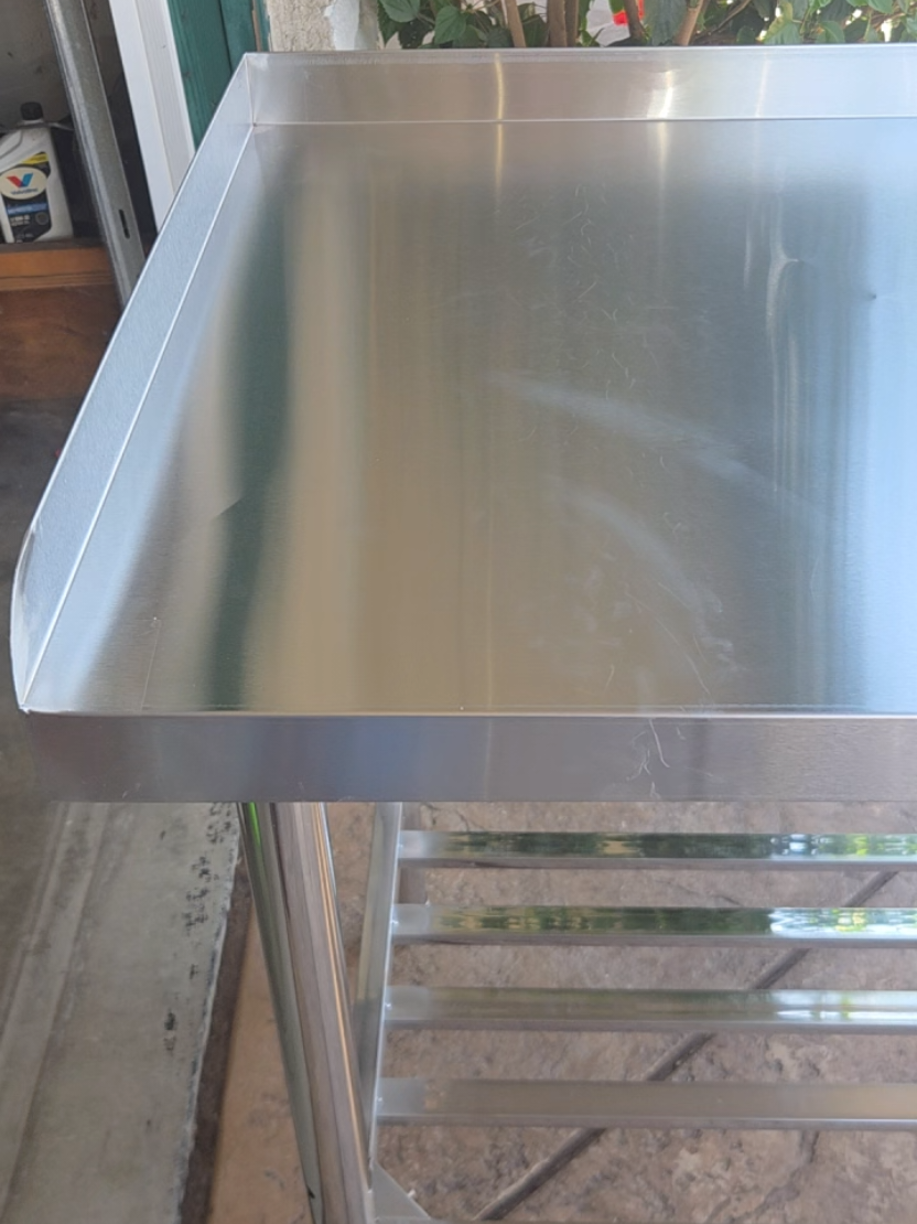 Upgrade your workspace with this GARVEE stainless steel work table. It features a smooth easy-clean work surface, 3-sided backsplash, and adjustable undershelf for extra storage. A practical setup for kitchens, garages, workshops, food prep areas, or anywhere you need a sturdy work surface with storage underneath. #StainlessSteelTable #WorkTable #KitchenOrganization #GarageOrganization #HomeImprovement