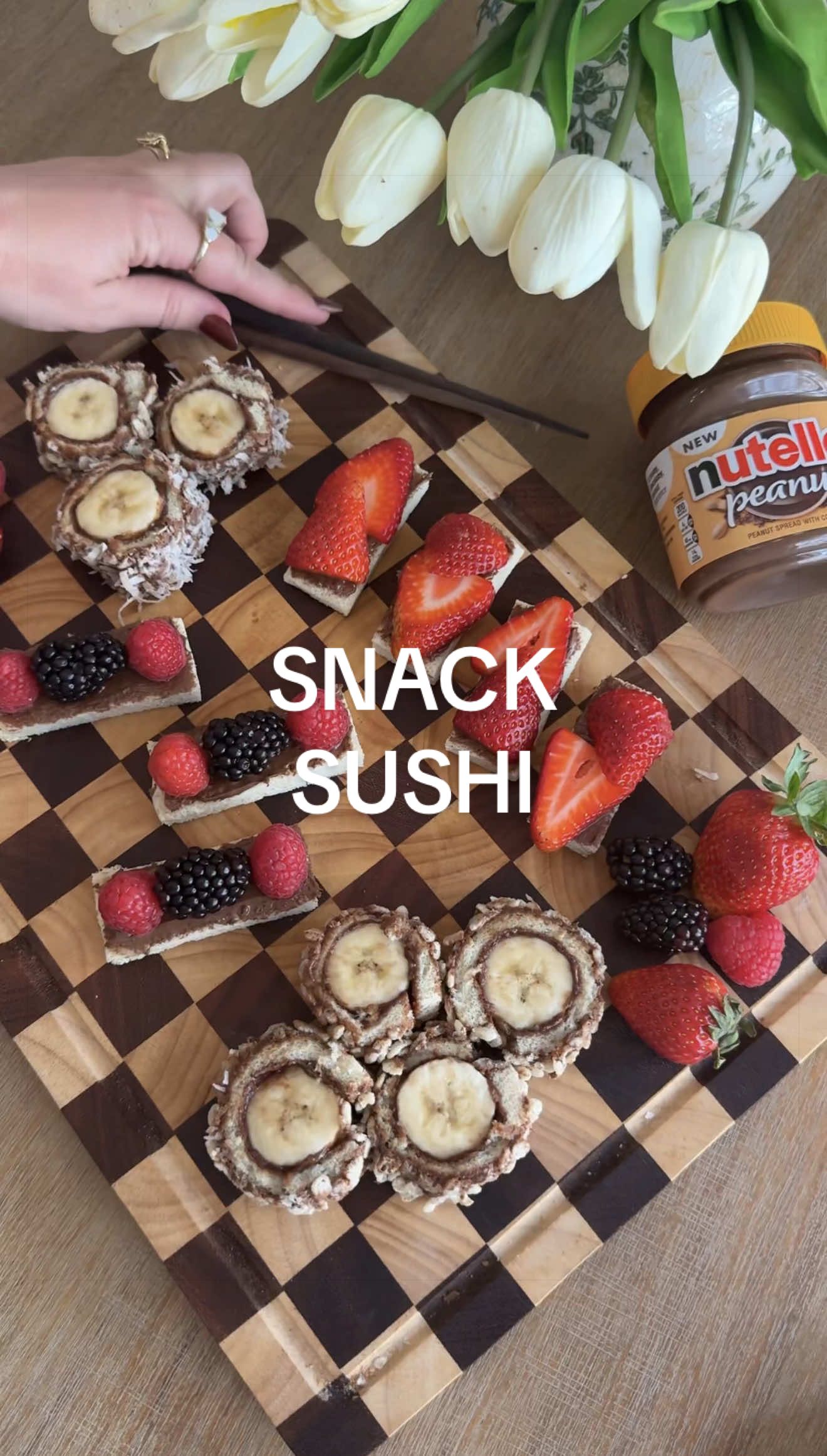 Ep. 2: NUTELLA PEANUT SNACK SUSHI 🍣 #ad #nutellapeanutpartner  Honestly what could be better than chocolatey little “sushi” bites! My kids were obsessed with these and they took all of 5 minutes to put together. And the new Nutella Peanut was the perfect spread for this! Instructions: - Roll out some soft white bread with a rolling pin (don’t skip this step or the bread will tear when you roll it up!) - Spread with some Nutella Peanut, add a banana and roll it up! - Then spread more on the outside and roll it in crispy rice cereal and/or sweetened coconut flakes for some fun texture before slicing into sushi rounds - You can also make “sashimi” with sliced strawberries and other berries! Try new Nutella Peanut today and let me know what kind of snack we should make next! @nutellausa #afterschoolsnack #dessertsushi #kidssnacks 