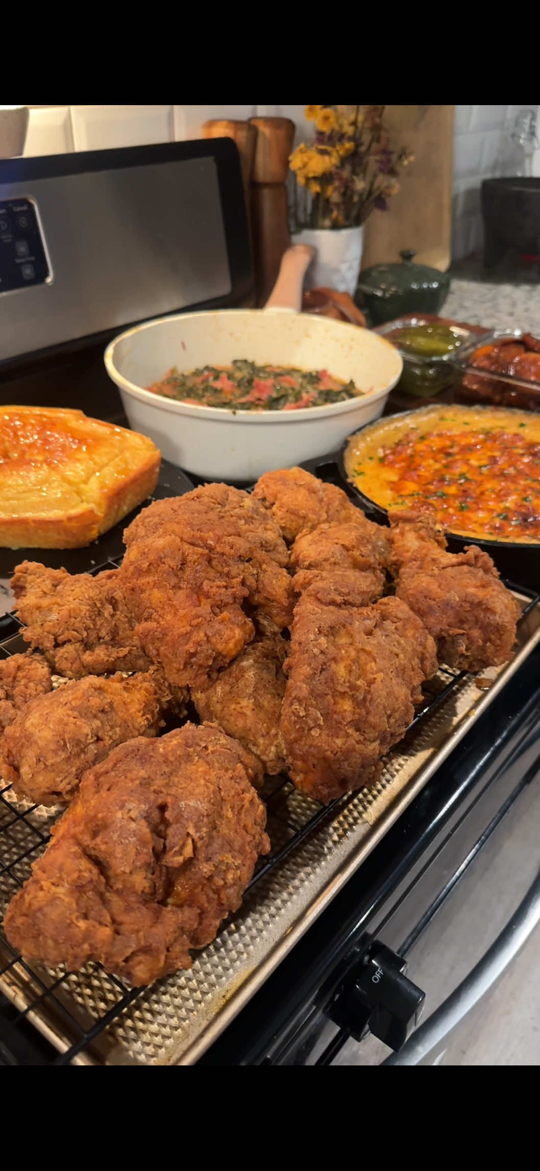 First time making soul food for dinner, I loved it 🤤 Fried chicken and corn bread recipe from @Toni Chapman  Mac and cheese recipe is already up on my page!  Yams:  3 large sweet potatoes seasoned heavily with cinnamon  8 tbsp (1 stick) unsalted butter  1.5 cups dark brown sugar  1 tbsp cinnamon  Grated nutmeg 1 tbsp Vanilla bean paste  pinch of salt  Baked at 400 degrees for 60-90 mins varying by thickness of sweet potatoes    Brown butter roasted banana pudding: Custard- 3 roasted bananas 6 large egg yolks 2 cans evaporated milk 1/2 cup dark brown sugar 1/4 cup cornstarch  1 vanilla bean pod  pinch of salt 3 tablespoons unsalted butter + 1 tbsp whole milk powder (browned) -Cream cheese  1 cup sweetened condensed milk 1 tbsp vanilla bean paste  Whipped cream: 2 cups HWC  1/2 cup dark brown sugar  1 tbsp vanilla bean paste  pinch of salt  1 bag vanilla wafers  Instructions: Roast 3 bananas at 350 for 20 mins or until fully brown and soft. Blend half a can of evaporated milk with bananas and add with additional 1.5 cans of evaporated milk, and 1 vanilla bean pod (paste or extract work too) to a saucepan and heat over medium low heat. In a bowl whisk yolks, brown sugar, cornstarch, and salt. Temper the mixture slowly to avoid scrambling, sift custard back into saucepan, and cook until thickened. Once thickened add in brown butter, sift back into a bowl, cover with plastic wrap (touching the custard), and allow to cool fully. Mix cream cheese, condensed milk, vanilla paste and salt until smooth, then add and fold into cold custard. Fold in whipped cream and reserve a portion to add top layer. Add in wafers, and finish with more cookies. Let sit in fridge a minimum of 6 hours, preferably 12+.  #friedchicken #collardgreens #macandcheeserecipe #macandcheese #bananapudding 