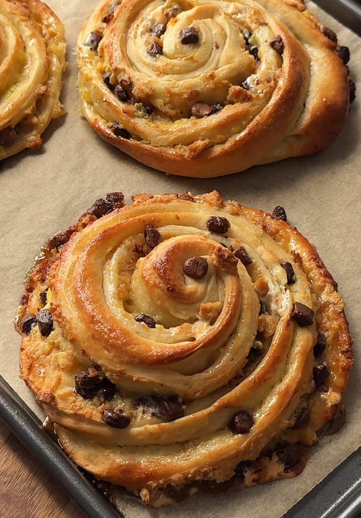 S’mores Rolls:  Recipe for 8-9 large rolls:  - 250 ml whole milk (38 °C) - 50ml double cream (= heavy cream)  - 75g sugar - 7g instant yeast  - 3g salt - 165 g strong white bread flour - 385g T45 flour (or just more strong white if you don’t have t45)  - 70g unsalted butter, cubed - 130 milk chocolate chips  - 200ml thick vanilla custard (recipe in the comments)  - 60g biscuits, crushed (I used malted biscuits, digestives would work well too)  - 70g mini marshmallows  - simple syrup to brush (2 tbsp caster sugar mixed with 2 tbsp boiling water)  In the bowl of your stand mixer, add warm milk, sugar, cream, starter and yeast first. Then add both flours and the salt. Mix on low for 3min and medium speed for 3min.  Go back to low speed and add the butter little by little. Continue kneading for 10-12min min more until smooth and the butter fully incorporated  cover and let rise in a warm spot (25–28 °C) for about 90min until almost doubled Roll the dough into a 55×40 cm rectangle (roughly).  Spread the custard evenly, then the chocolate chunks, crushed biscuits and marshmallows.  Fold the dough twice - put in the freezer for 10min (it will harden the dough and custard and shaping will be easier).  Slice into long strips (8 for large rolls).  Roll each stripes into a snail shape and flatten slightly Place on baking trays lined with baking paper and let rise in a warm place for around 60min, until puffy.  Preheat your oven to 175c. Brush the buns with the egg wash.  Bake for 18-20min  until slightly golden. Brush with the syrup while still hot.  #baking #smores #brioche #homebaker 